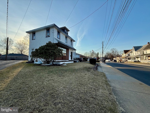 view of side of property featuring a lawn