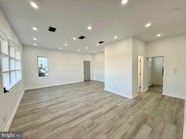 spare room with recessed lighting, visible vents, baseboards, and light wood-style floors