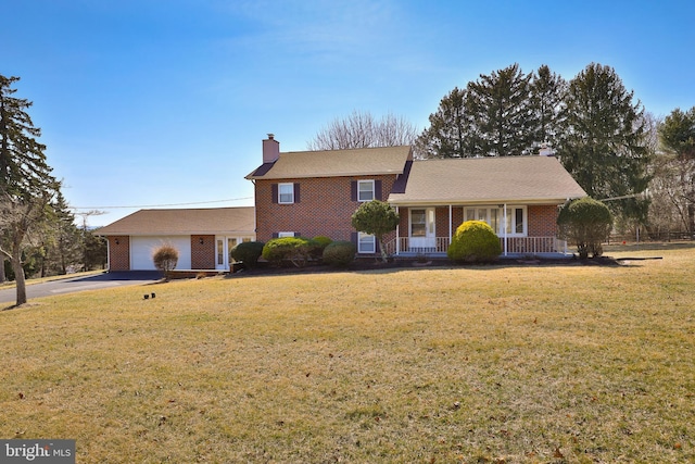 split level home with aphalt driveway, covered porch, an attached garage, brick siding, and a chimney