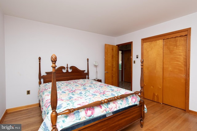 bedroom featuring a closet, baseboards, and light wood-style flooring