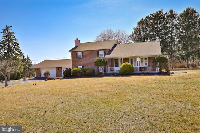 tri-level home with brick siding, a porch, a chimney, a garage, and driveway