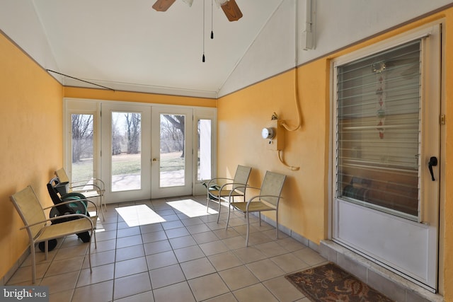 sunroom / solarium with french doors, a ceiling fan, and vaulted ceiling