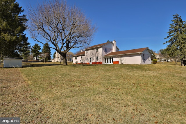 view of yard with a storage shed and an outdoor structure