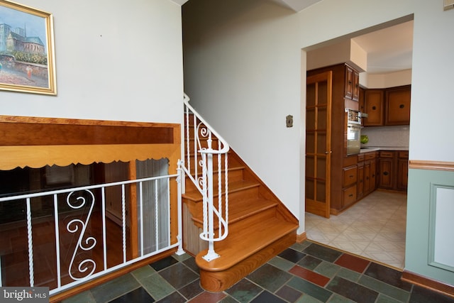 staircase with tile patterned floors