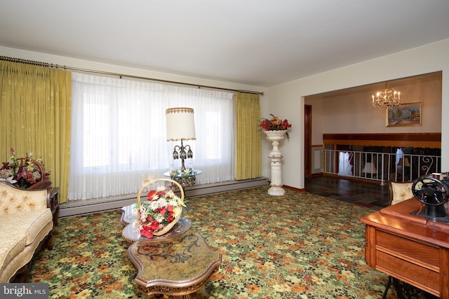 living area with a baseboard radiator and an inviting chandelier