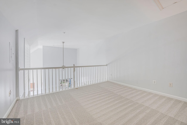 carpeted spare room featuring baseboards