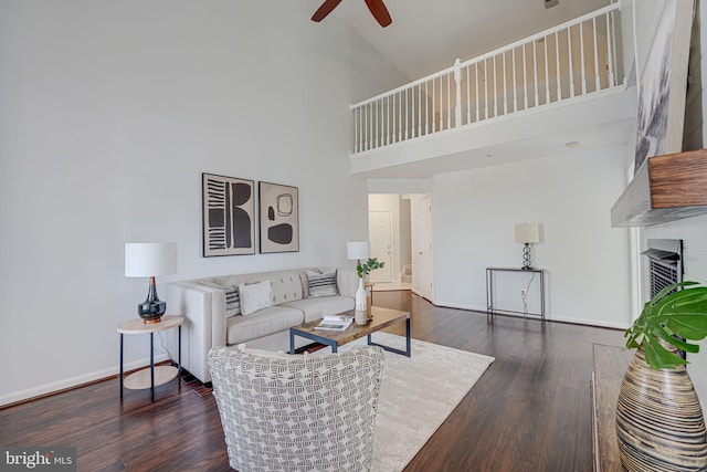 living room with baseboards, high vaulted ceiling, ceiling fan, and hardwood / wood-style flooring