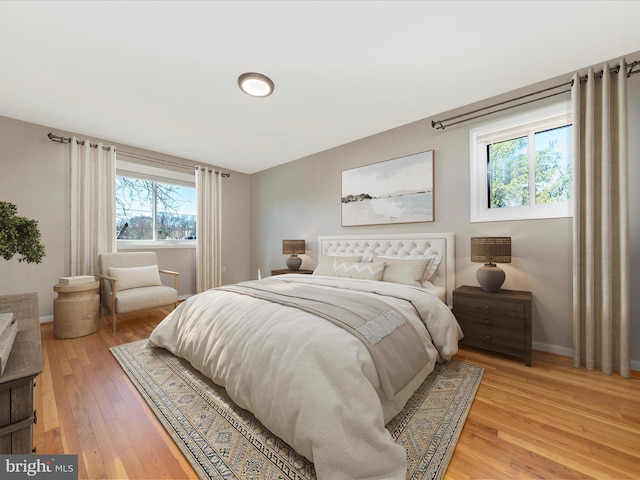 bedroom featuring light wood-type flooring and baseboards