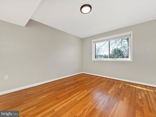 empty room with light wood-type flooring and baseboards