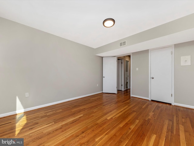 interior space with visible vents, baseboards, and light wood-style floors