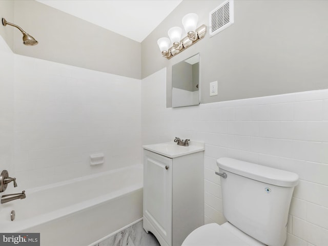 bathroom with a wainscoted wall, visible vents, shower / bath combination, tile walls, and toilet