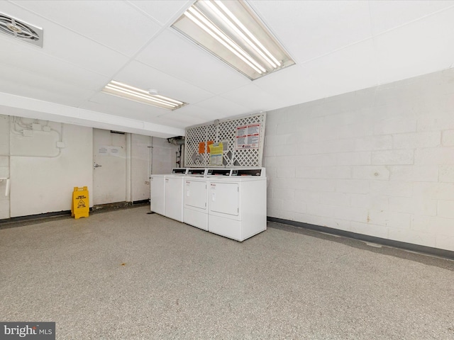 interior space with visible vents, washer and dryer, laundry area, and concrete block wall