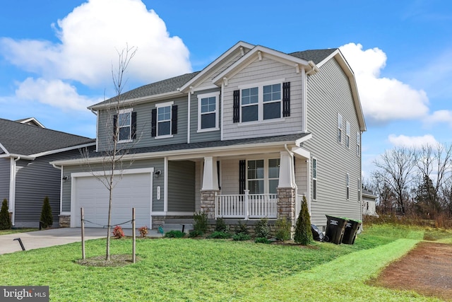 craftsman-style house with driveway, stone siding, a porch, a front yard, and a garage