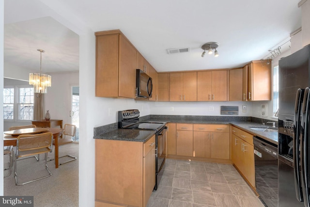 kitchen with visible vents, decorative light fixtures, dark stone counters, an inviting chandelier, and black appliances