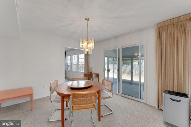 carpeted dining space featuring heating unit and an inviting chandelier