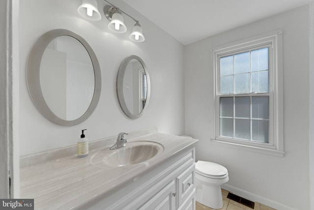 bathroom with visible vents, baseboards, toilet, tile patterned floors, and vanity