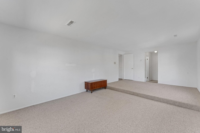 empty room with visible vents and carpet floors