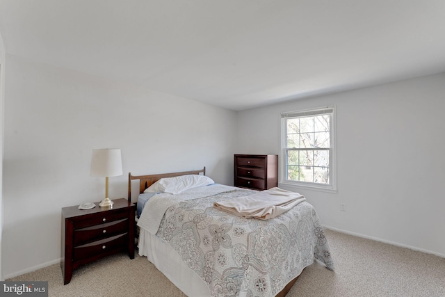 bedroom with baseboards and carpet floors