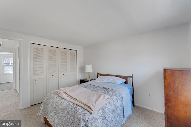 bedroom featuring baseboards, a closet, and carpet floors