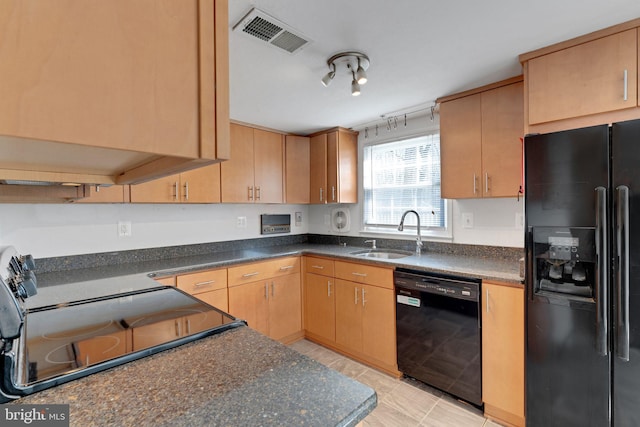 kitchen with visible vents, a sink, black appliances, track lighting, and dark countertops