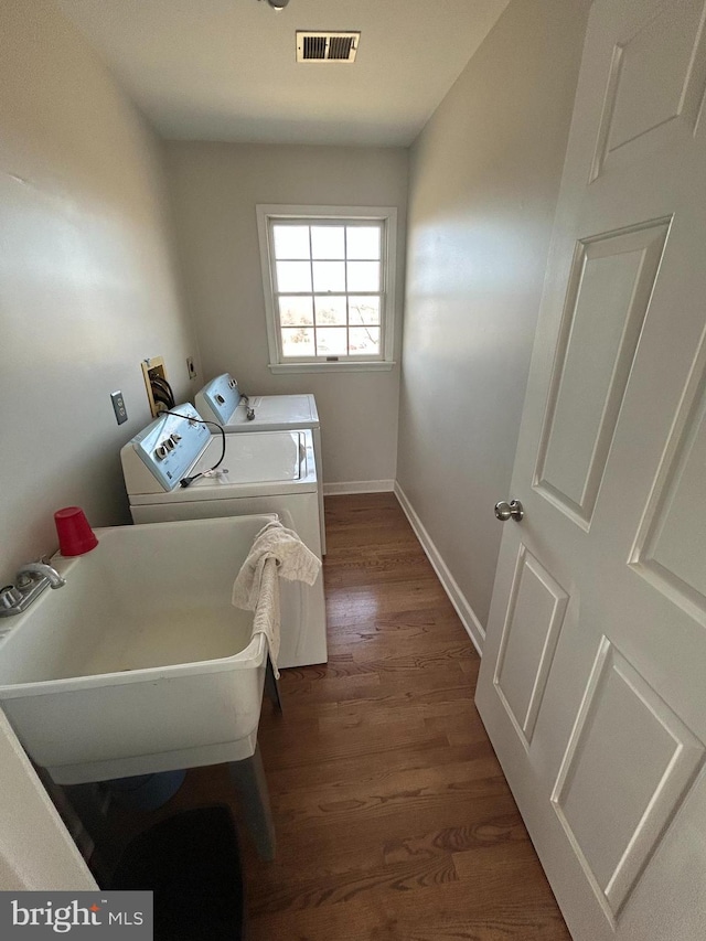 laundry area featuring visible vents, washer and clothes dryer, dark wood finished floors, baseboards, and laundry area