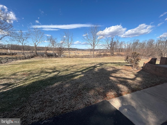 view of yard with a rural view