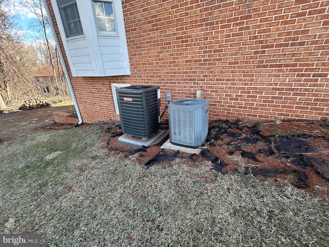 details featuring brick siding and central AC