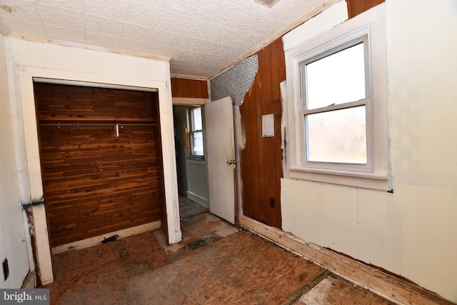 spare room featuring wood walls