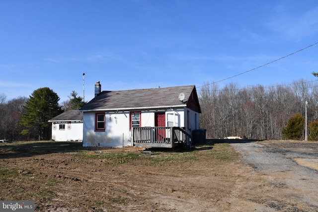 view of front of house featuring driveway and a chimney