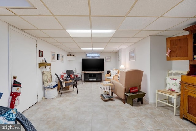 living area with a drop ceiling