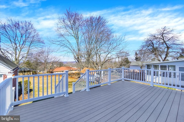 wooden deck featuring a yard