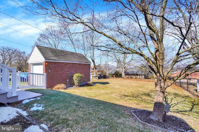 view of yard featuring an outbuilding and a garage