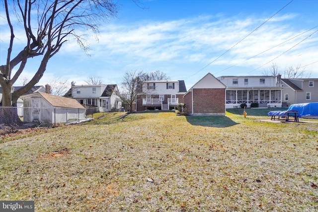 view of yard with a residential view, fence, and a sunroom