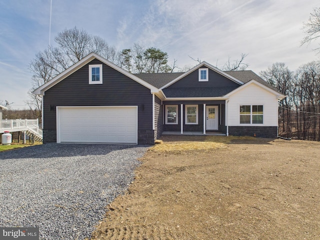 craftsman inspired home with an attached garage, fence, covered porch, stone siding, and driveway