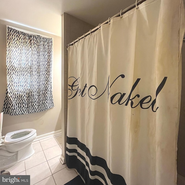 full bathroom with tile patterned flooring, curtained shower, and toilet