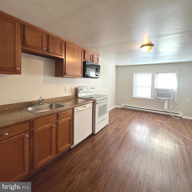 kitchen with dark wood finished floors, baseboard heating, brown cabinets, white appliances, and a sink