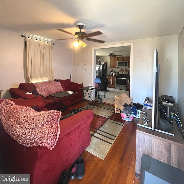 living area featuring a ceiling fan and wood finished floors