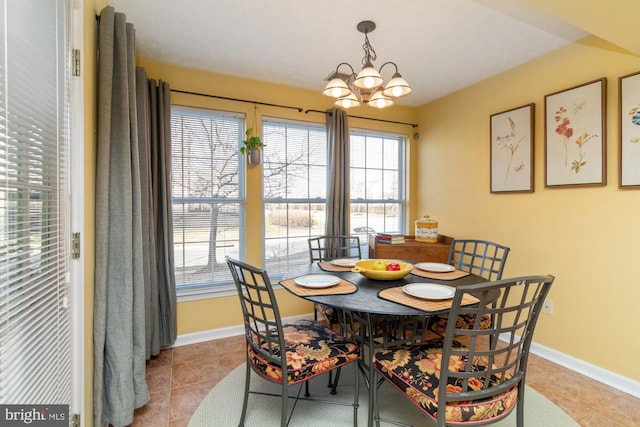 dining space featuring a wealth of natural light, light tile patterned floors, and baseboards