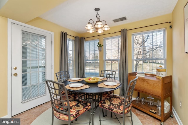 dining space featuring a notable chandelier, visible vents, a healthy amount of sunlight, and light tile patterned flooring