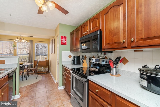 kitchen featuring black appliances, backsplash, a textured ceiling, light tile patterned flooring, and brown cabinetry