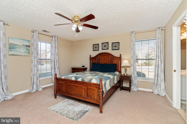 bedroom with visible vents, light colored carpet, a ceiling fan, and baseboards