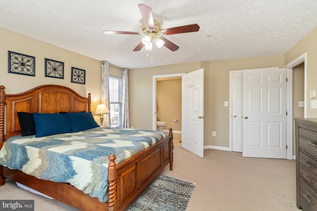 bedroom featuring light colored carpet, a textured ceiling, baseboards, and ceiling fan