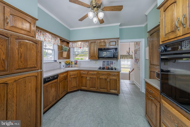 kitchen featuring black appliances, light countertops, brown cabinets, and backsplash