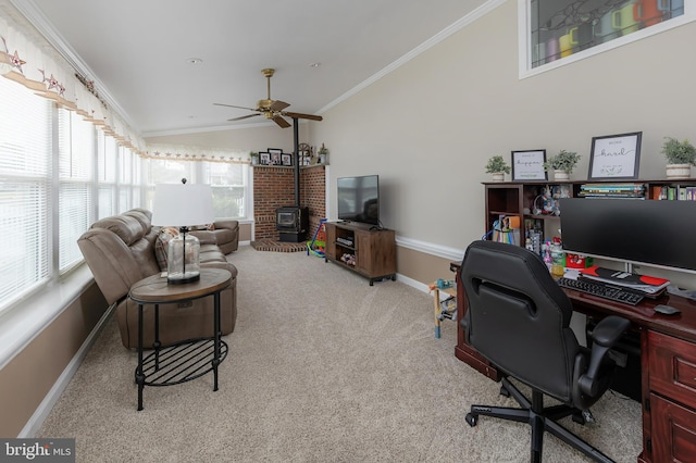 home office featuring carpet floors, crown molding, lofted ceiling, ceiling fan, and a wood stove