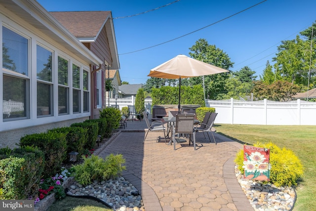 view of patio featuring a fenced backyard and a hot tub