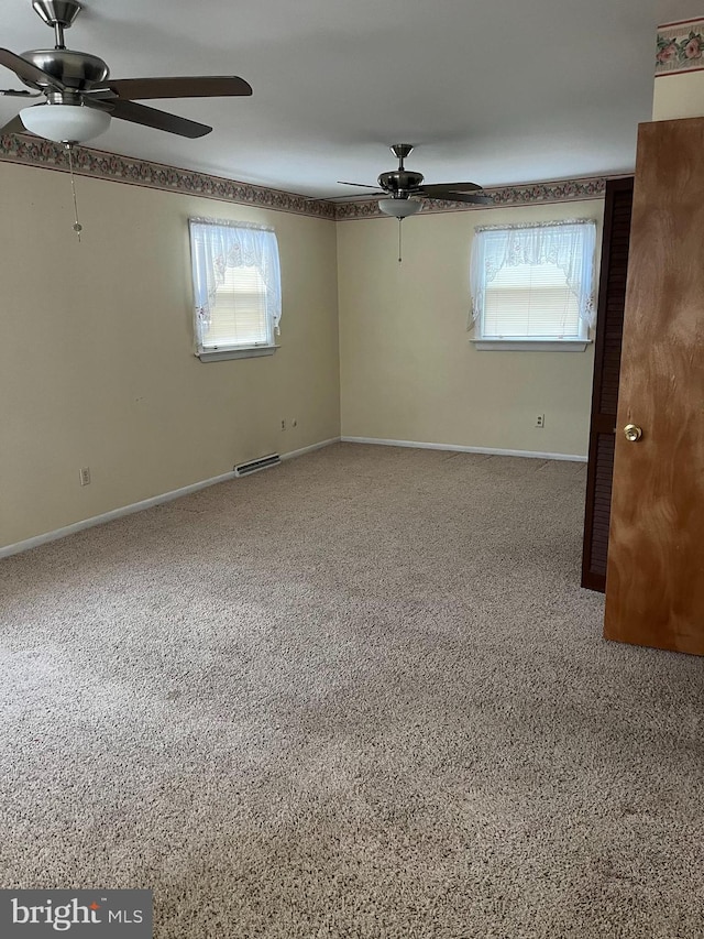 spare room with a ceiling fan, baseboards, and visible vents