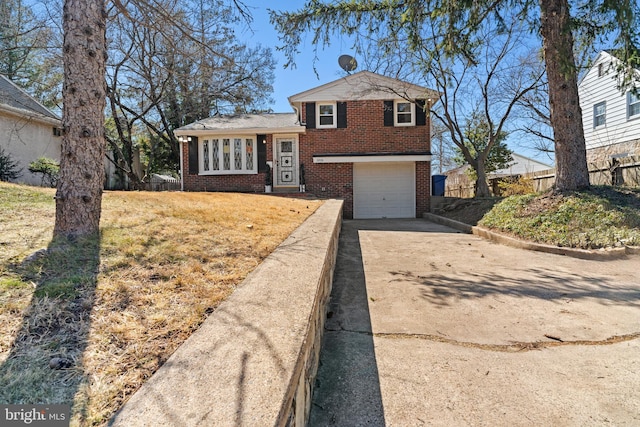 tri-level home featuring an attached garage, brick siding, and driveway