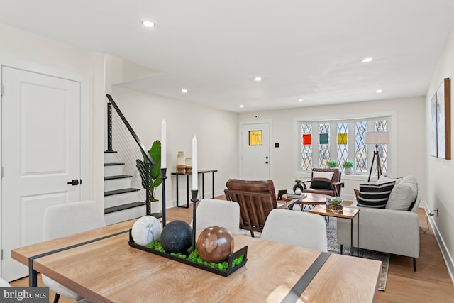 dining area with stairs, recessed lighting, light wood-style floors, and baseboards