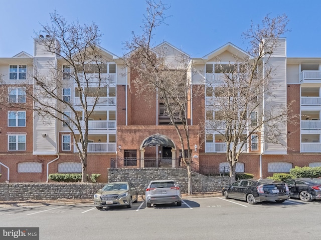 view of building exterior with uncovered parking