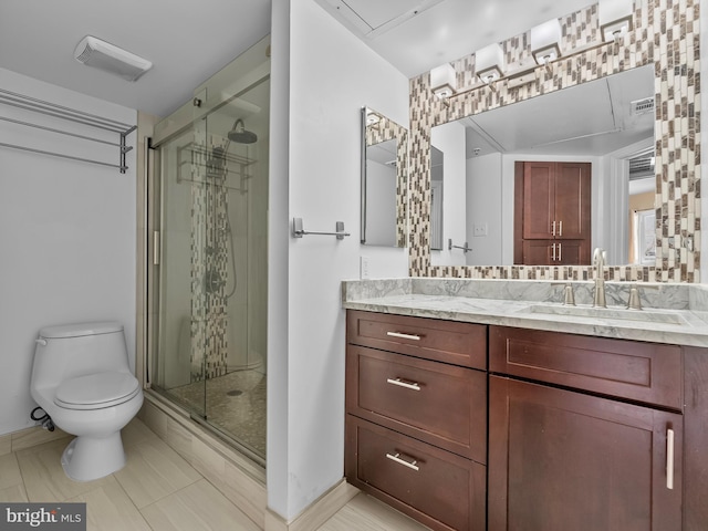 bathroom featuring visible vents, a shower stall, baseboards, toilet, and vanity